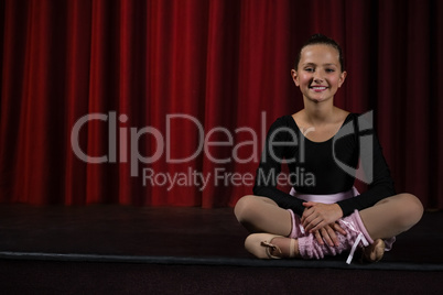 Ballerina sitting on the stage in theatre