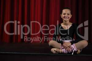 Ballerina sitting on the stage in theatre