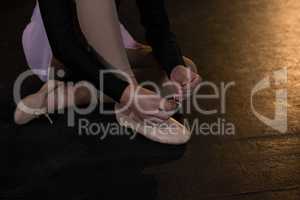 Ballerina tying her shoes