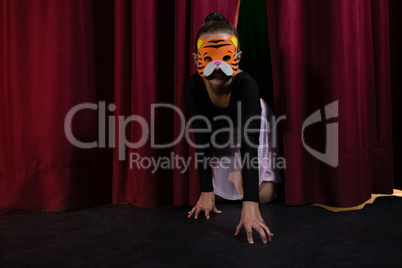 Ballet dancer wearing mask crawling