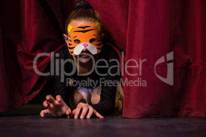 Ballet dancer wearing mask crawling