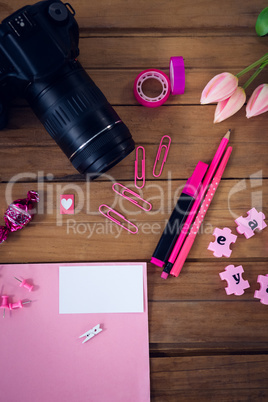 Directly abvoe shot of office supplies with camera and artificial tulip flowers