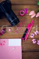 Directly abvoe shot of office supplies with camera and artificial tulip flowers