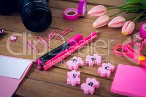 Close up of office supplies with camera and artificial tulip flowers