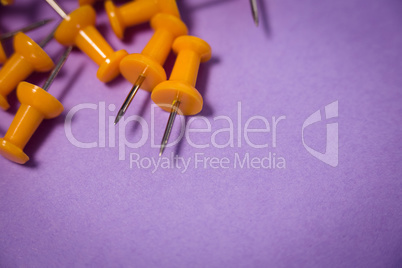 High angle view of yellow paper pins on paper