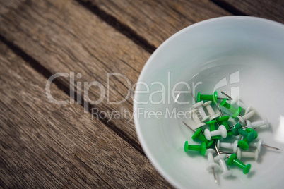 High agnle view of paper pins in bowl