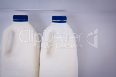 Close up milk bottles in refrigerator