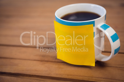 High angle view of adhesive note on coffee cup