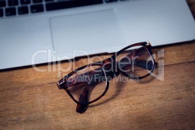 Close up of eyeglasses by laptop