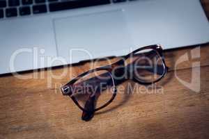 Close up of eyeglasses by laptop