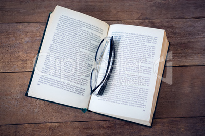 Close up of eyeglasses on book