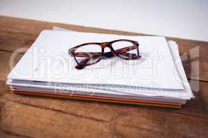 Close up of eyeglasses on documents