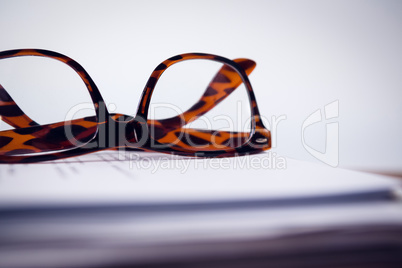 Close up of eyeglasses on paper