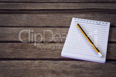 High angle view of notepad with pencil