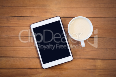 Directly above shot of digital tablet with coffee cup