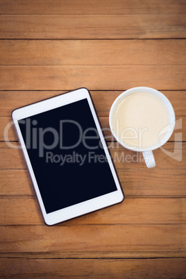 Overhead view of digital tablet with coffee cup