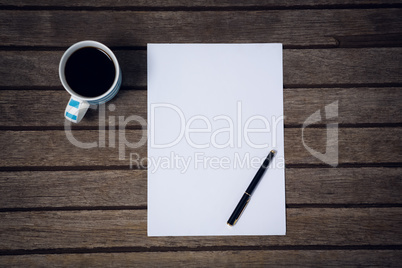 Directly above shot of paper and fountain by coffee cup