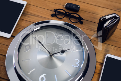 High angle view of wall clock with digital tablet and smart phone