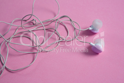 Pink earphones on pink background