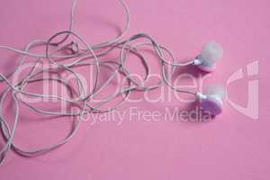 Pink earphones on pink background