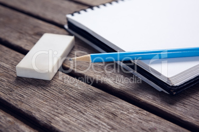 Close-up of pencil and eraser on open diary