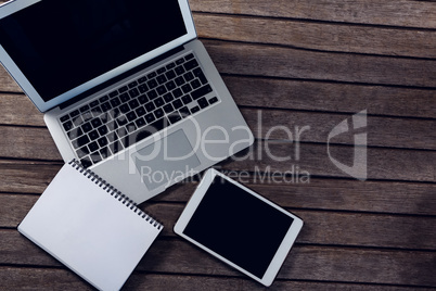 Laptop, digital tablet and diary on wooden table