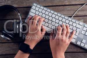 Executive typing on keyboard in office