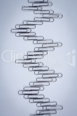Paper clips arranged on white background