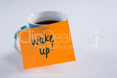 Black coffee with wake up message on white background