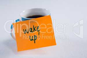 Black coffee with wake up message on white background