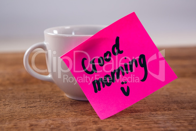 Black coffee with message on wooden plank