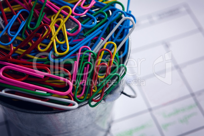 Colorful paper clips in bucket