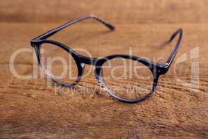 Spectacles on wooden table