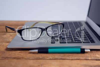 Close-up of spectacles on laptop