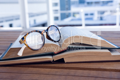 Close-up of spectacles on open book