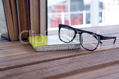 Close-up of spectacles on open book Close-up of spectacles on open book