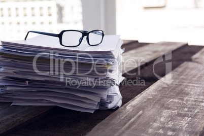 Close-up of spectacles on documents