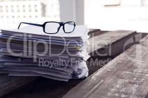 Close-up of spectacles on documents