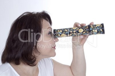 Adult woman looking into a kaleidoscope