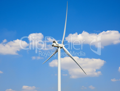 Top of a windmill against a blue sky