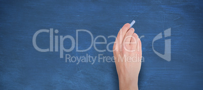 Composite image of hand writing with blue chalk