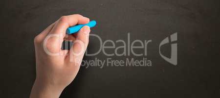 Composite image of hand holding blue chalk