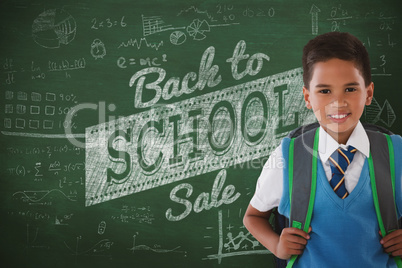 Composite image of portrait of schoolboy carrying schoolbag against white background