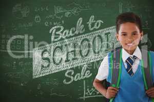 Composite image of portrait of schoolboy carrying schoolbag against white background