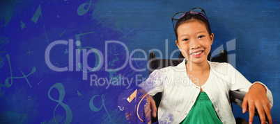 Composite image of young girl smiling while sitting on wheelchair