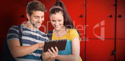 Composite image of happy students using tablet pc