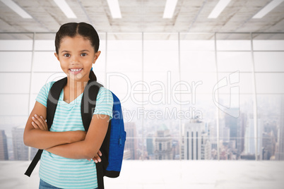 Composite image of portrait of smiling girl with arms crossed carrying bag
