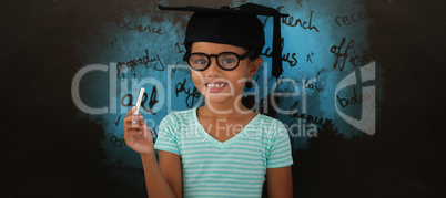 Composite image of portrait of smiling girl wearing mortarboard and holding chalk