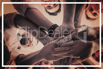 Portrait of smiling business colleagues with their hands stacked