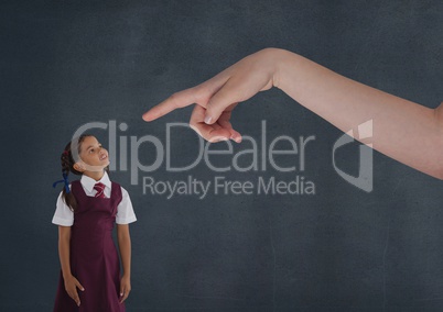 Hand pointing at girl looking up against blue background